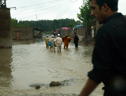 Aug. 9, 2010: People wade through flooded streets in Charsadda, Pakistan. Photo: U.K. Department of International  Development/Flickr