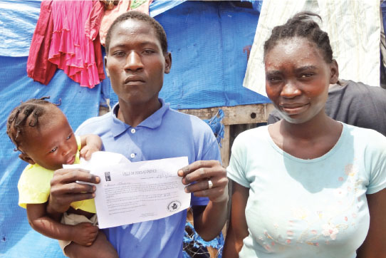 Champ de Mars camp residents show eviction notice, March 29, 2012, photo Stuart Neatby