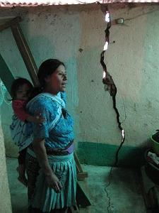 Crisanta Hernandez, at her home in Ágel, showing the cracks in her walls she believes were caused by mining activity in the area. Photo: Ruth Warner