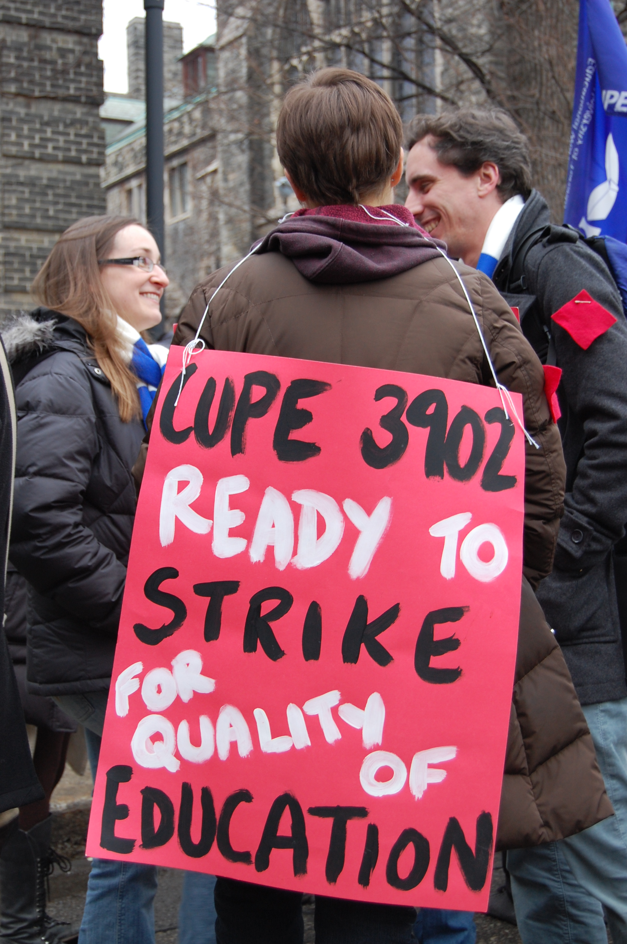 A protester wears a picket sign during a rally in support of CUPE 3902 on Feb. 16, 2012. Photo: Mick Sweetman