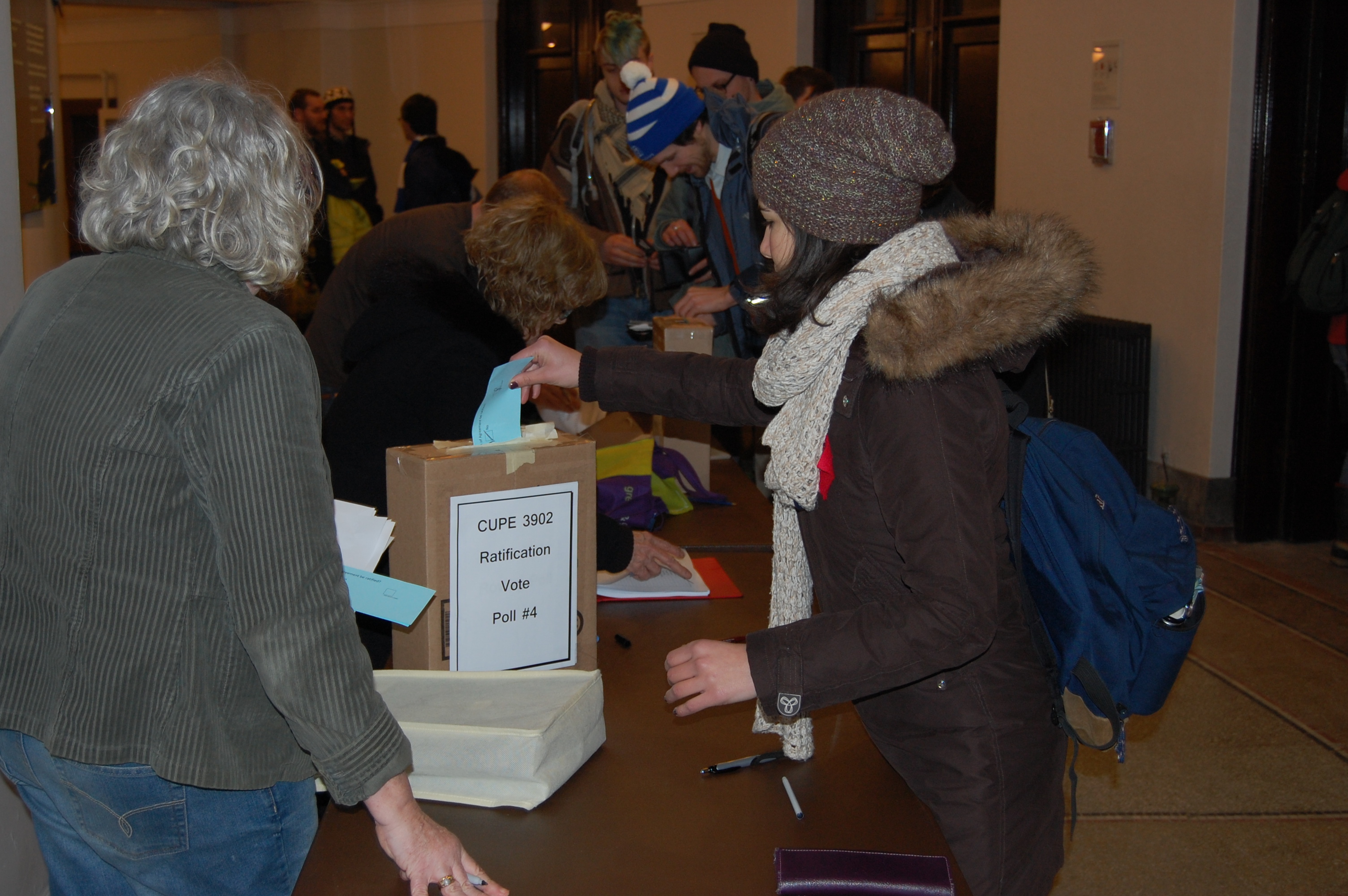 CUPE 3902 members vote on the proposed agreement after a five-hour mass meeting. Photo: Mick Sweetman