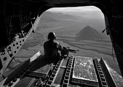 An American Chinook helicopter crewman looks out over the border region between Afghanistan and Pakistan in 2008, where the heaviest fighting occurred at that time. NATO forces have little presence in areas between major bases. Photo: Graham Lavery