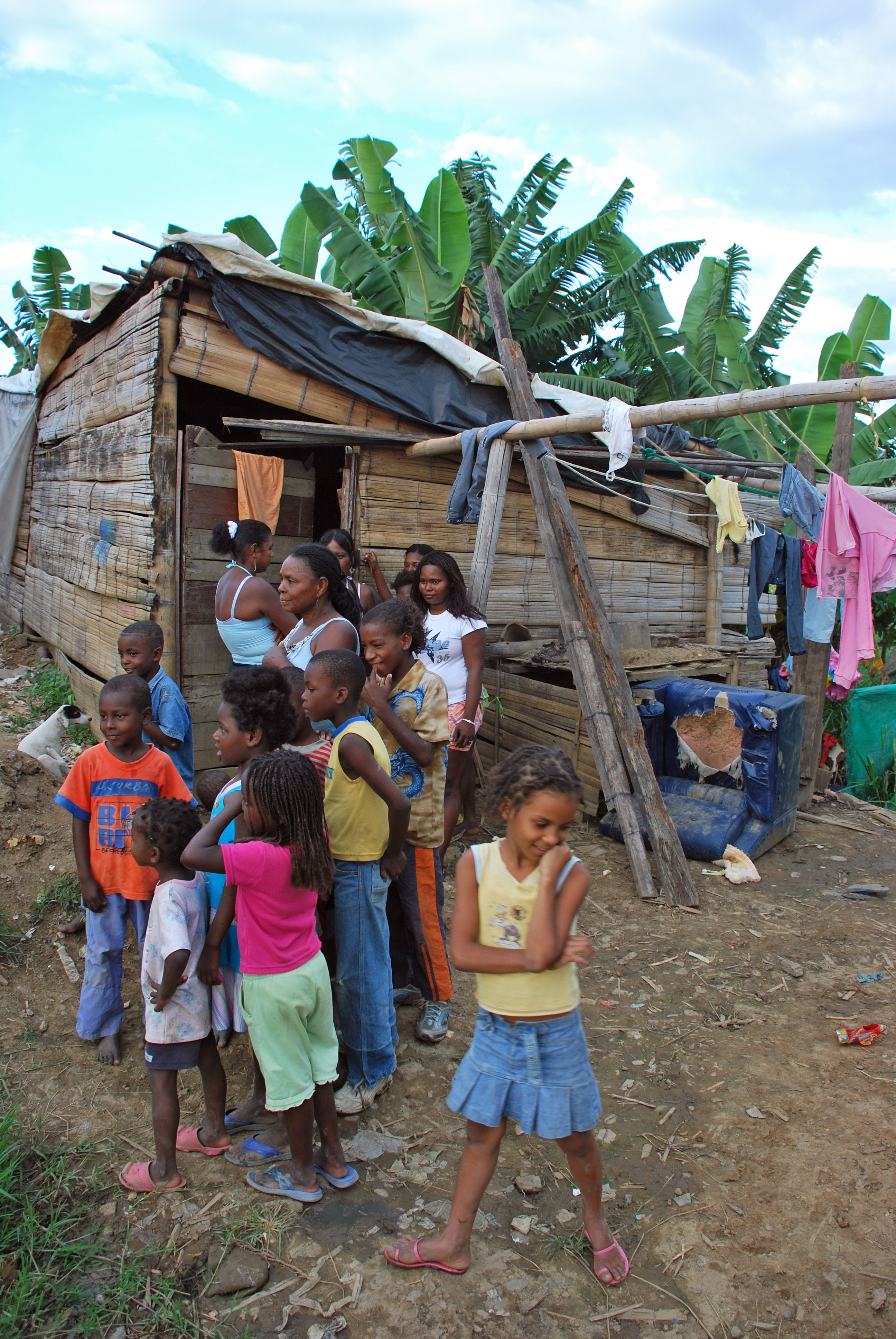Displaced persons gather outside makeshift home in Agua Blanca in Cali