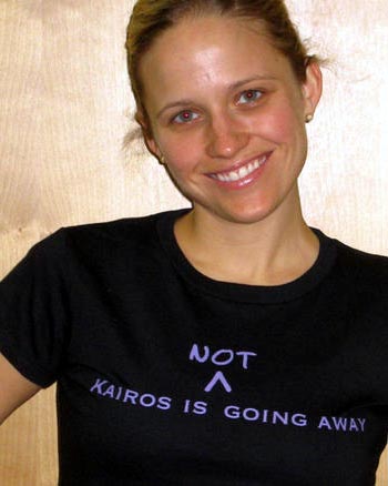 Kairos worker Caroline Foster shows off a new t-shirt poking fun at the decision to order that the word "not" be inserted on a government document that ended a 36-year funding arrangement with the church-backed aid organization. Photo: Kairos/Nik Beeson