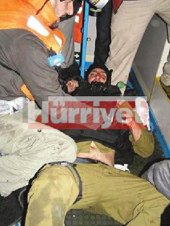 On board the Mavi Marmara as it was under attack: An Israeli commando soldier is panicked, but being treated for injuries after being captured by peace activists. Photo: Kevin Neish.