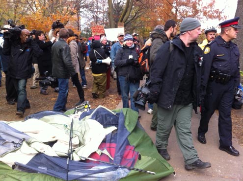 Police began securing eviction notices at the Occupy Toronto campsite in St. James Park on Monday, Nov. 21. Photo: Wayne MacPhail