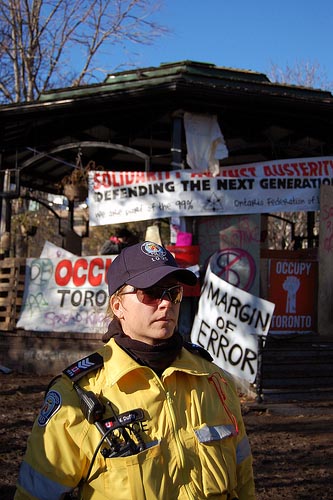 An officer waits on the day the Occupy Toronto camp is torn down, Nov. 23, 2011. Photo: Mick Sweetman.