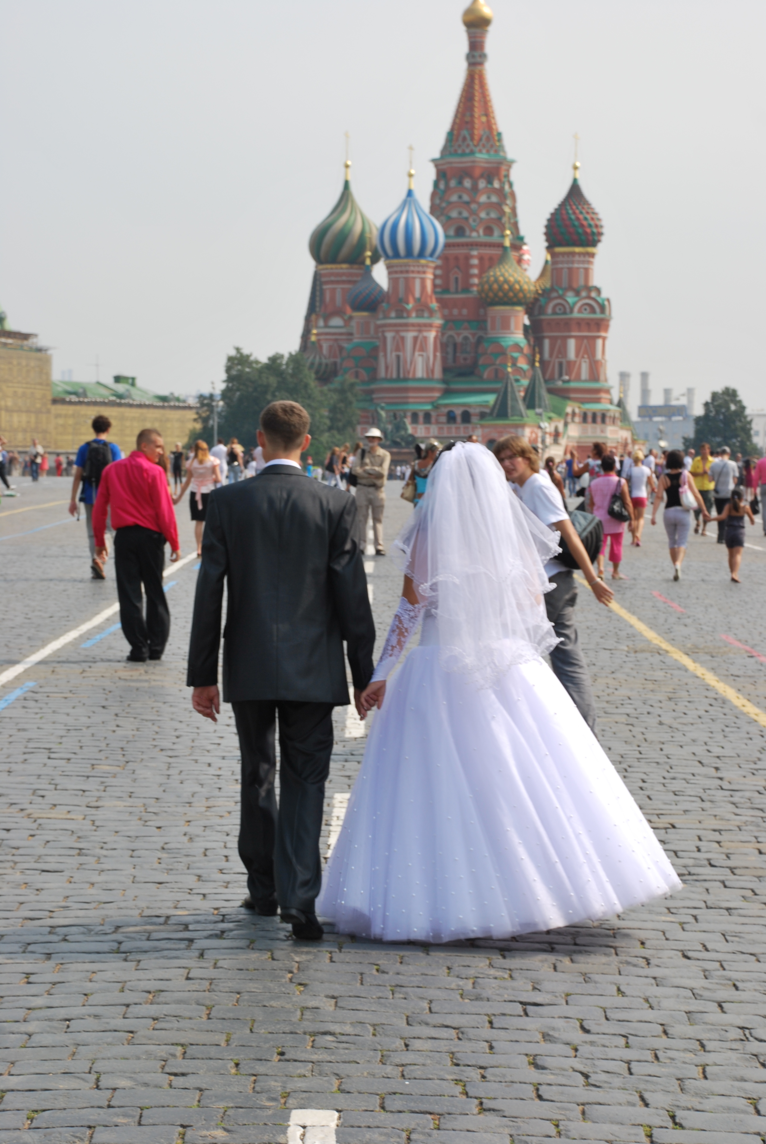 A bride and groom walk through Red Square. Photo: Ron Verzuh