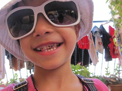 'A little girl is fascinated by my camera and puts on my hat and sunglasses. She doesn't speak any English, but, as always with kids, it doesn't really matter.' Photo: Rachel Marcuse