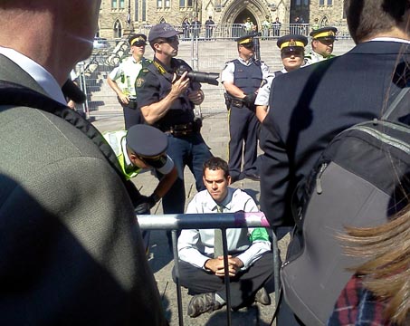 An RCMP officer speaks to a protester in Ottawa on Monday, Sept. 26, 2011 at the anti-tar sands protest. Photo: Marco Vigliotti