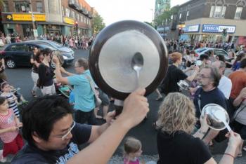 A protester bangs on a pan during a Quebec student protest