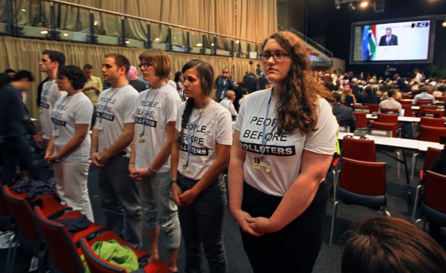 Youth from the Canadian Youth Delegation turn their back on Environment Minister Peter Kent during his remarks in Durban Climate talks.