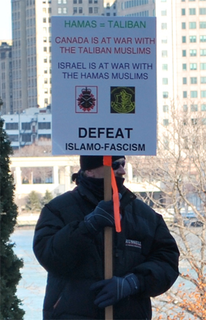 Protestor with sign: "Defeat Islamo-Fascism"