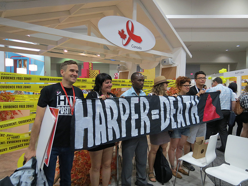 Activists deliver a message in front of the Canadian booth at the international