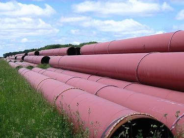 Stacked pipes in a field. Photo: Loozrboy/Flickr