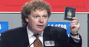 Jean Charest waves his passport at 1995 "no" rally. Photo: cbc.ca