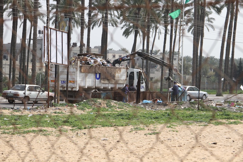 A United Nations truck removes waste from a Gaza refugee camp. Photo by Emad Bad