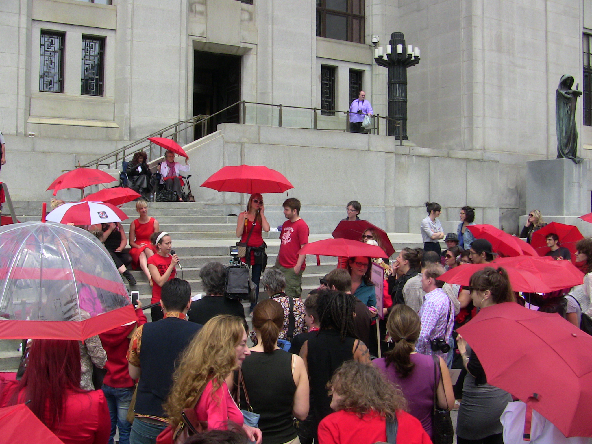 Emily Symons addressing a rally Thursday outside the Supreme Court.