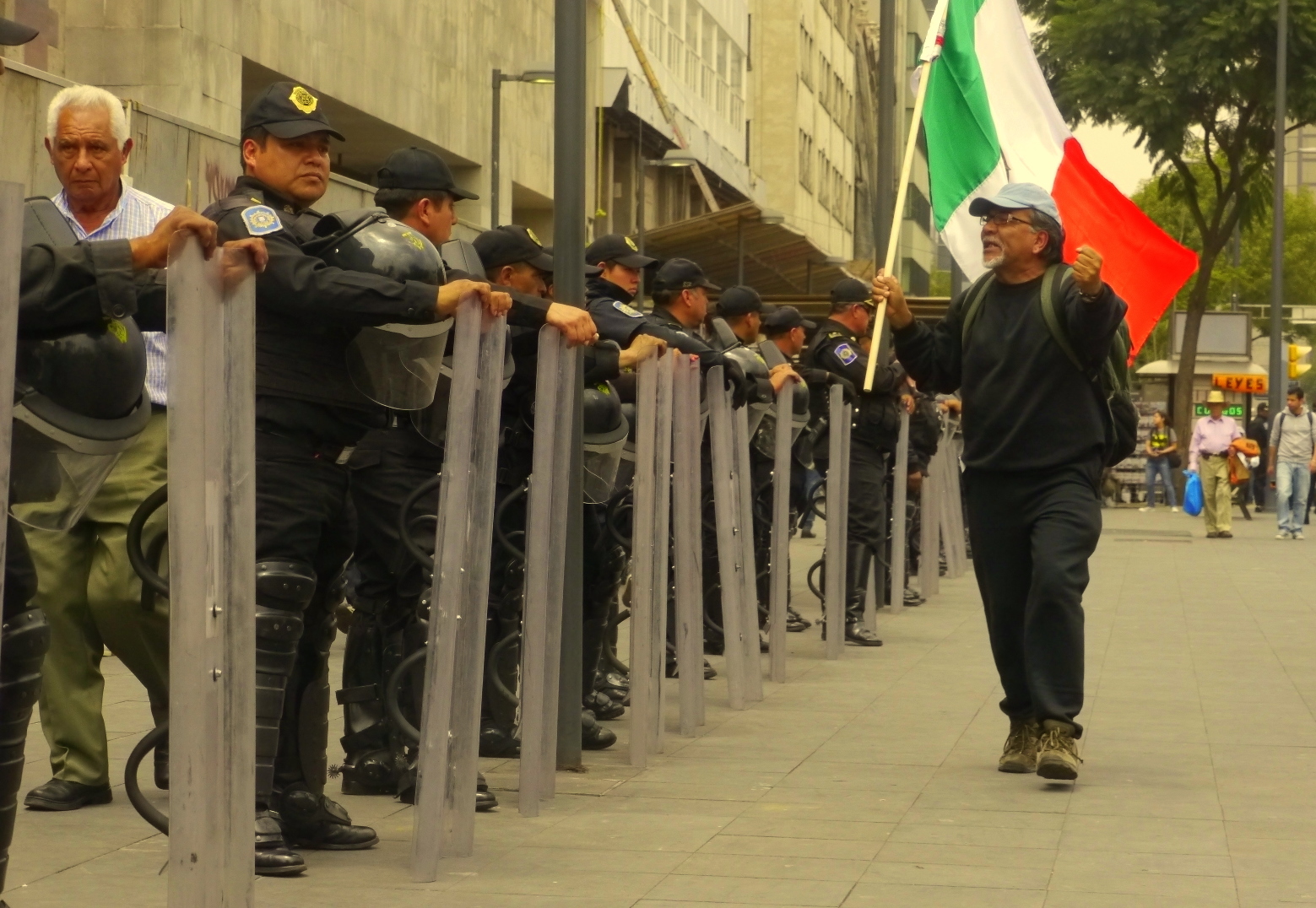 angry-man-with-flag-in-front-of-police