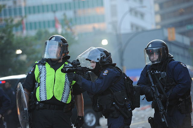 Image: "VPD anti-riot officers" by Charles de Jesus . Licensed under CC BY 2.0 v