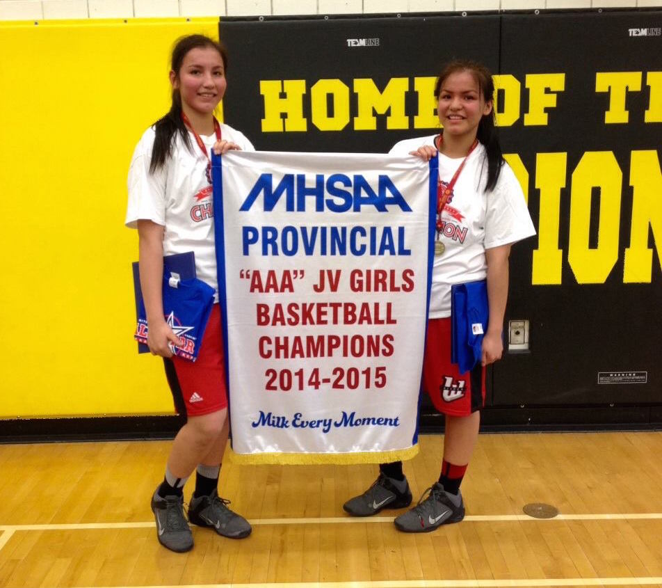 Alicia and Rachelle Dunsford with their AAA Junior Varsity Championship banner.