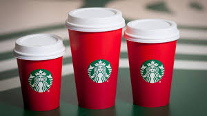 Three paper coffee cups with Starbucks logos