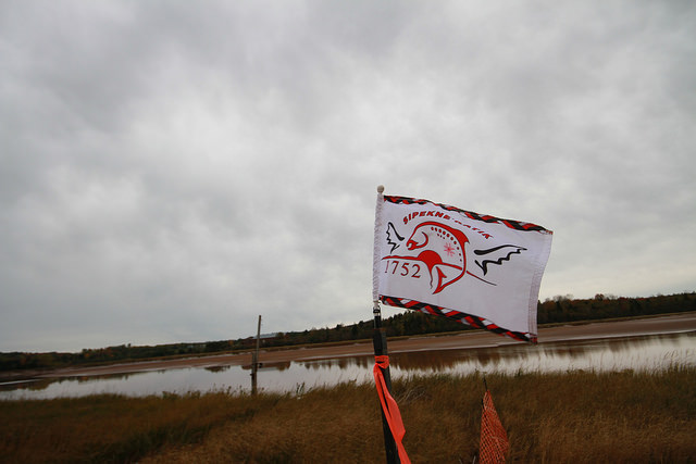 Photo: Sipekne'katik flag waves at the proposed brine storage site, Tori Ball