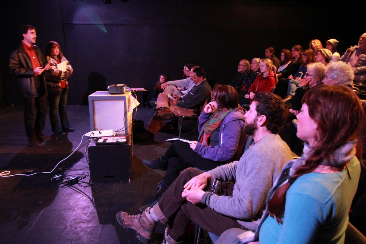 Photo: Council of Canadians board member Moira Peters and packed audience listen