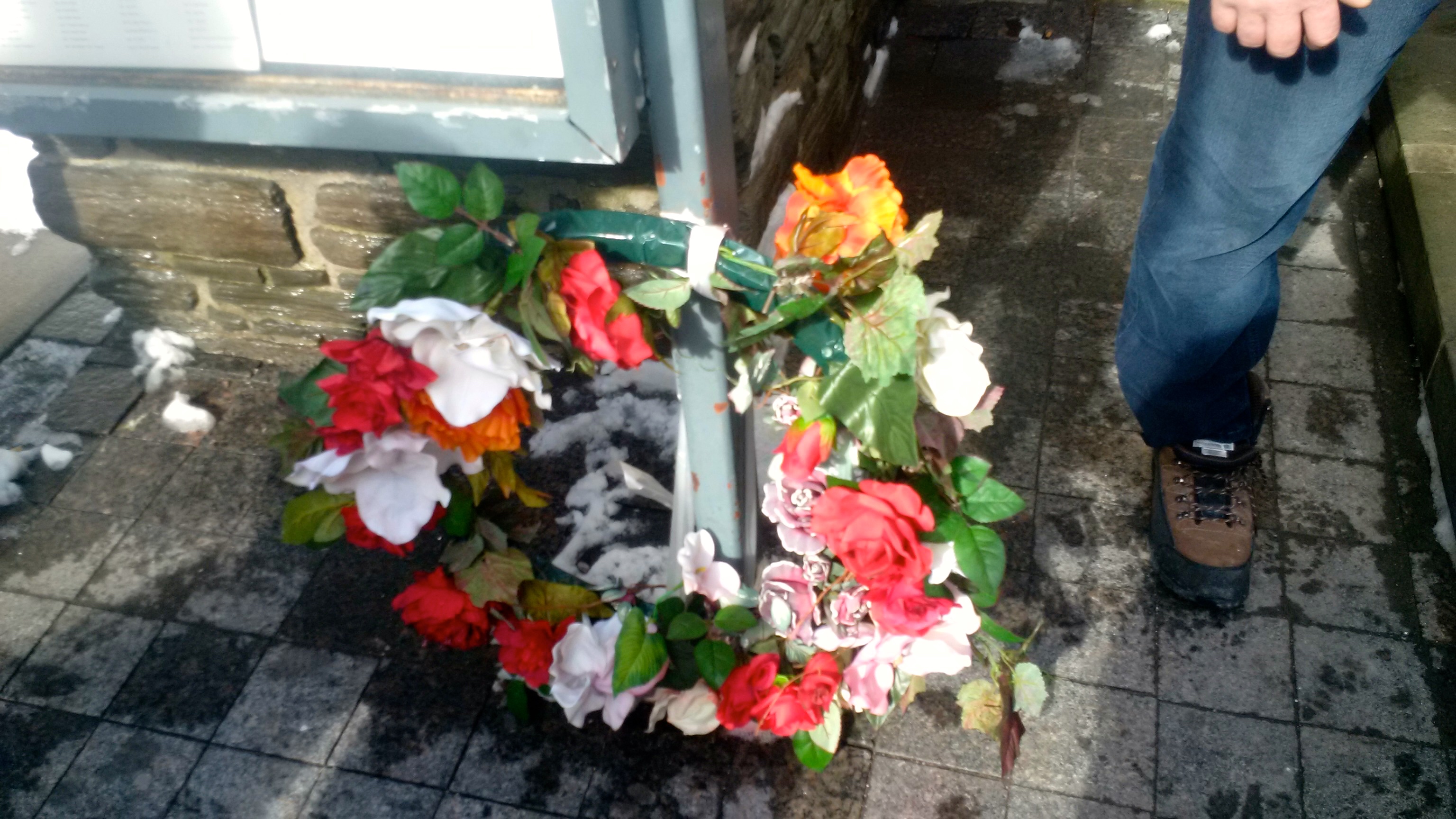 A colourful wreath attached to the Toronto Homeless Memorial