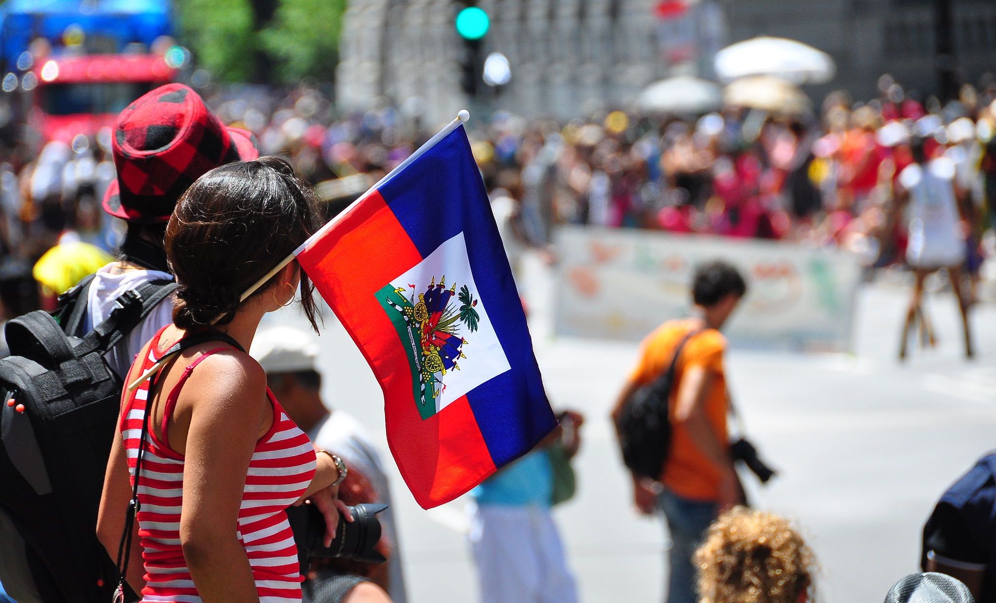 A small Haitian flag waving in front of a crowd.