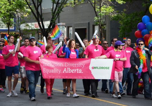 Then-Wildrose MLAs Kerry Towle, leader Danielle Smith and Jeff Wilson (all behind the sign) take part in the August 2014 Calgary Pride parade.