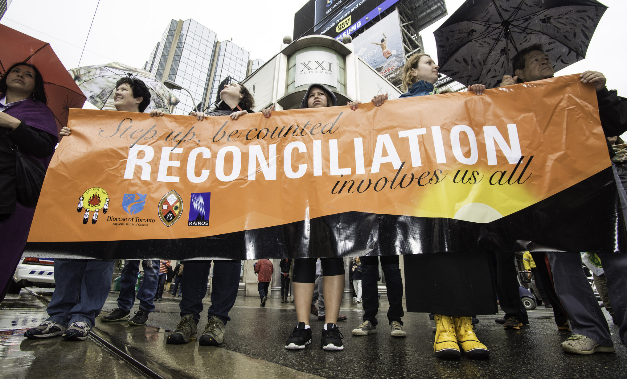 People hold banner titled "reconciliation" Photo: michael_swan/flickr