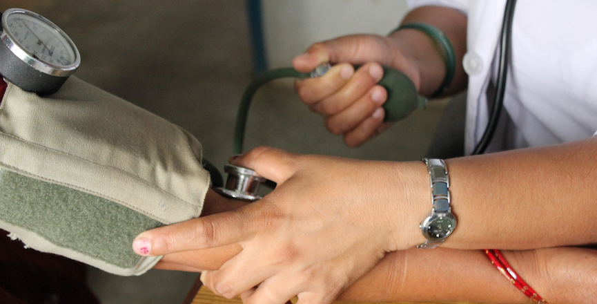 Close up of doctor taking blood pressure.  Image: World Bank Photo Collective/flickr