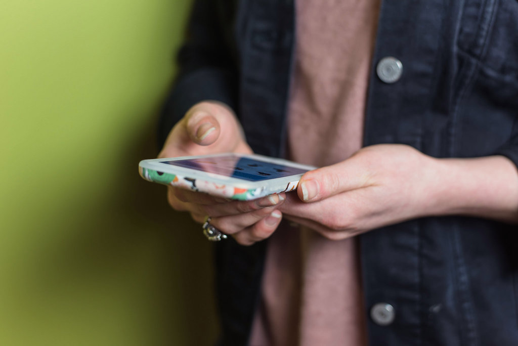 Woman holding phone. Photo: MadFishDigital/flickr