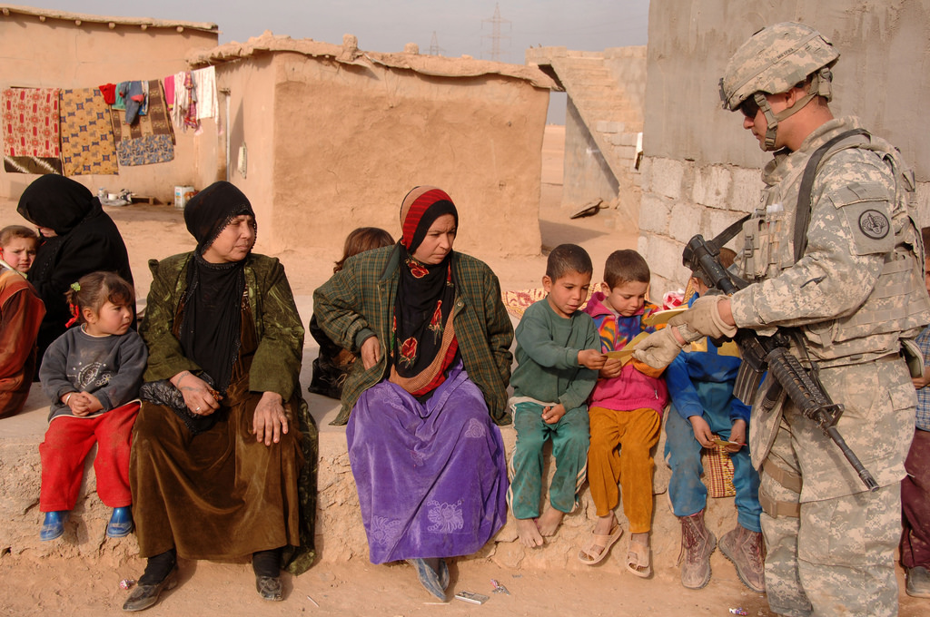 A U.S. Army soldier attached to 3rd Squadron, 3rd Armored Cavalry Regiment hands out informational flyers in Mosul, Iraq, Jan. 4, 2008. Photo: U.S. Army/Spc. Kieran Cuddihy