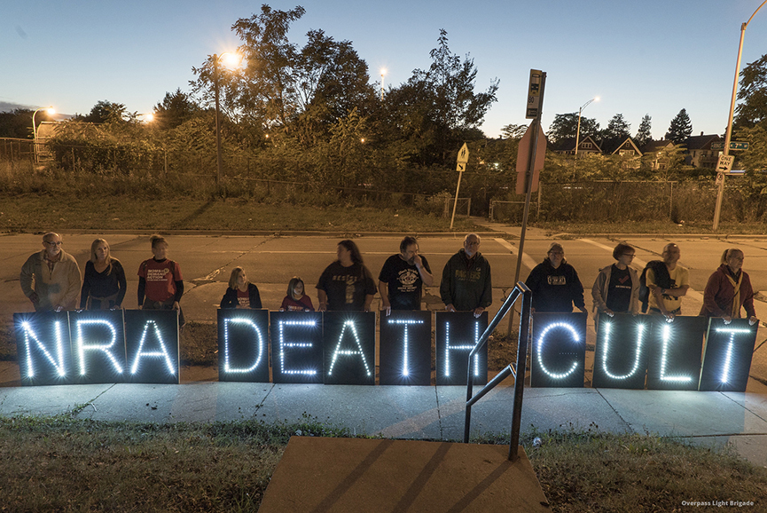 "NRA death cult" sign at protest. Image: Joe Brusky/Flickr