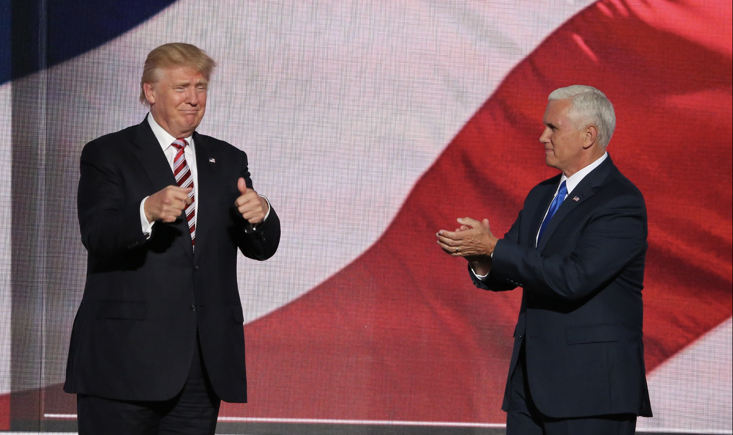 Republican presidential nominee Donald Trump, left, gives his running mate, Indiana Governor Mike Pence, a thumbs up after Pence addressed the Republican National Convention. Photo: A. Shaker/VOA