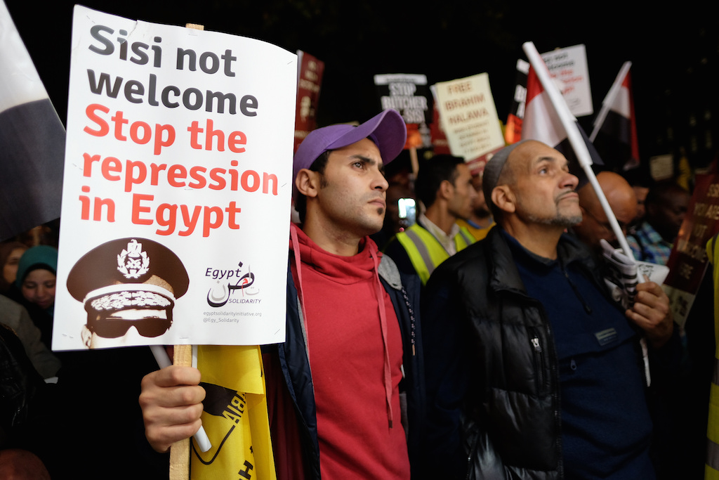 Protesters hold anti-Sisi signs. Photo: Alisdare Hickson/flickr