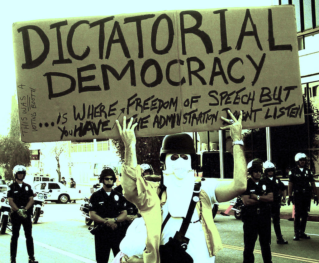 Protester holding sign "dictatorial democracy" Photo: The Prophet/flickr