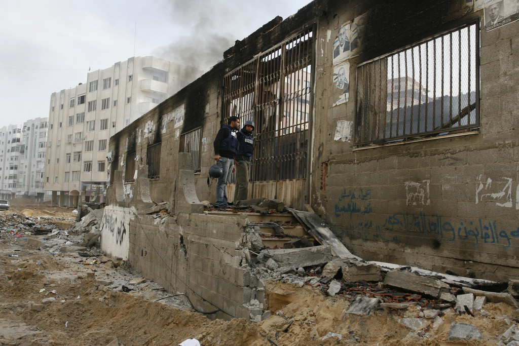 Journalists inspect building after it was burned by the Israeli military. Photo: Al Jazeera English/Flickr