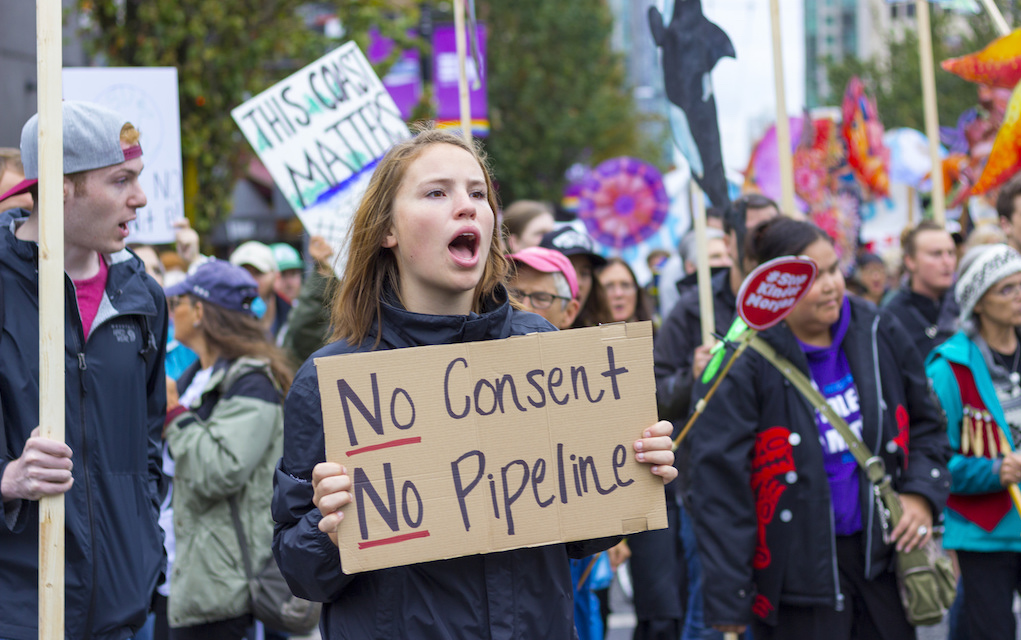 Woman holds sign at Vancouver Kinder Morgan protest. Photo: William Chen/Flickr