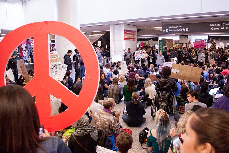 Giant_peace_sign_at_SFO_-noban_Protest_-Jan_29,_2016_(31793130293)