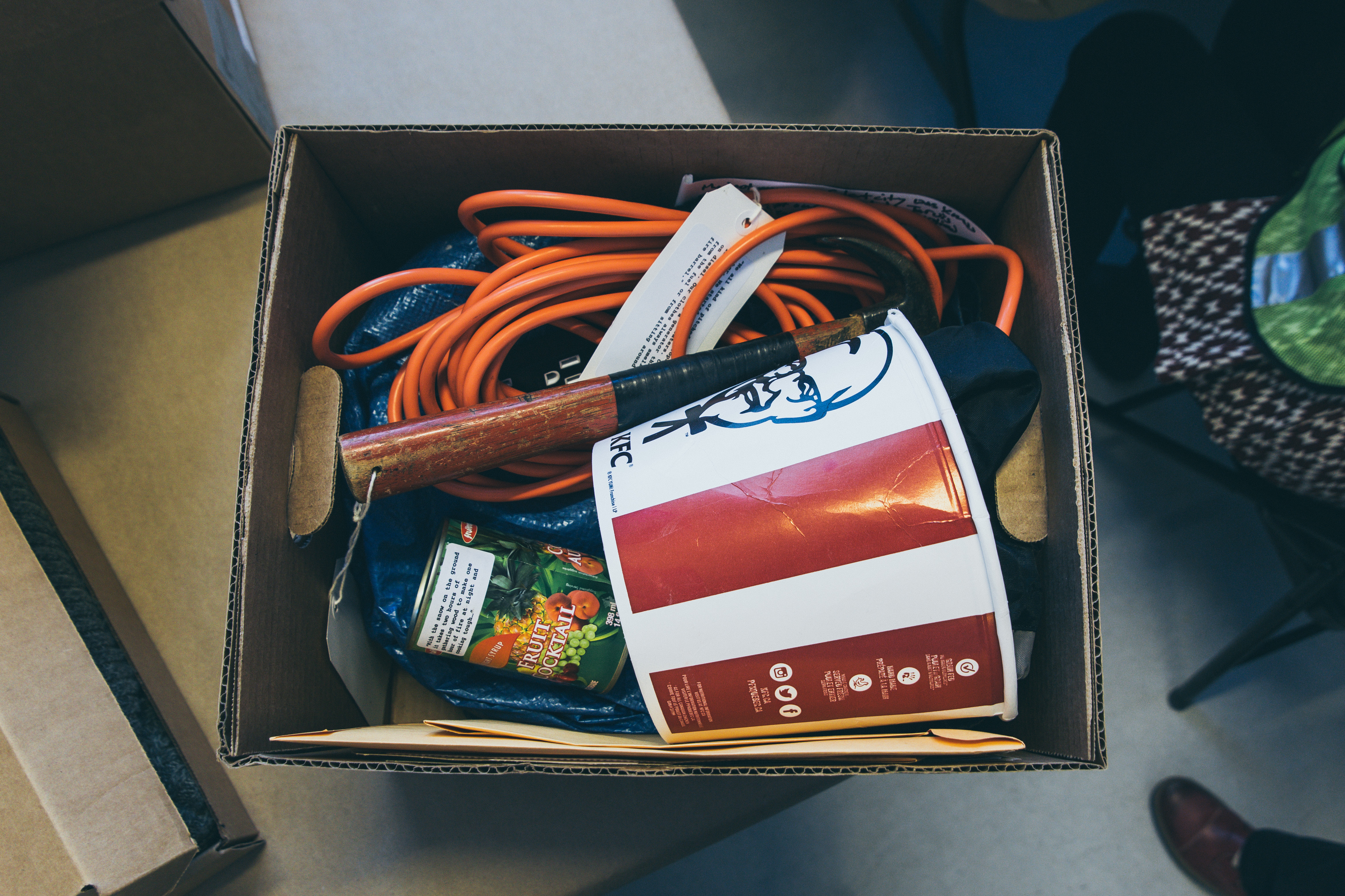 A box in the Tent City memory archive shows a KFC box, can of fruit, hammer, electrical cord. Photo credit: Nicole Brumley