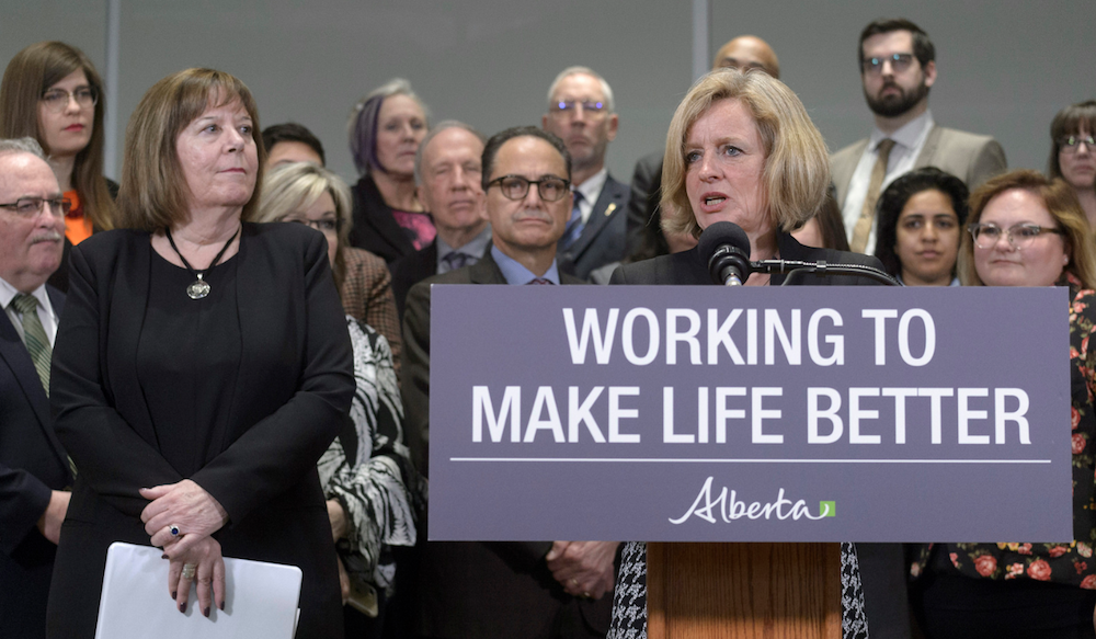 Alberta Energy Minister Margaret McQuaig-Boyd looks on as Premier Rachel Notley speaks about Bill 12 yesterday (Photo: Government of Alberta/Flickr).