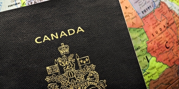 Canadian passport on globe. Image: Flickr