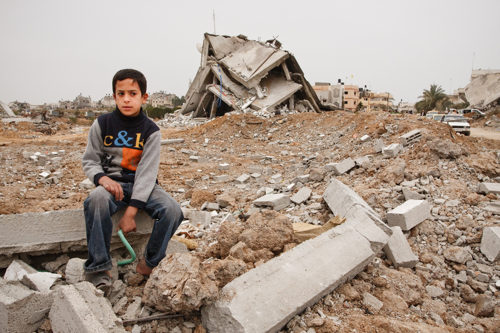 Child sits near wreckage in Gaza. Photo: andlun1/Flickr