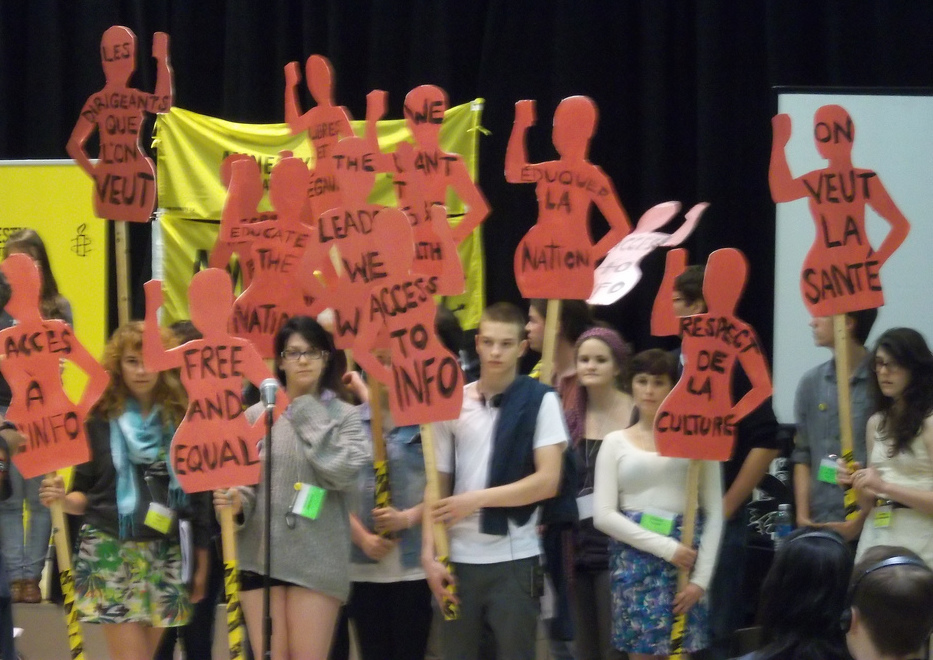 People holding signs with human rights messages on them. Photo: Geoff Campbell/Flickr