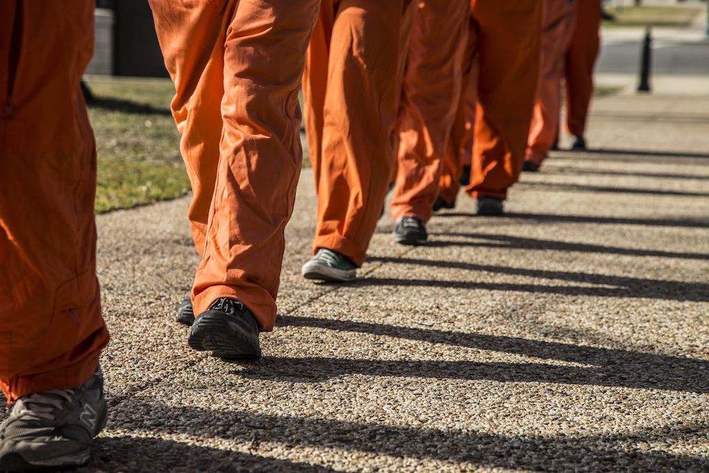 Protesters dressed as Guantánamo prisoners march through Washington, D.C. Photo: Justin Norman/Flickr