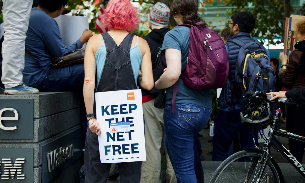 Woman holds net neutrality sign. Photo: CDEL Family/Flickr