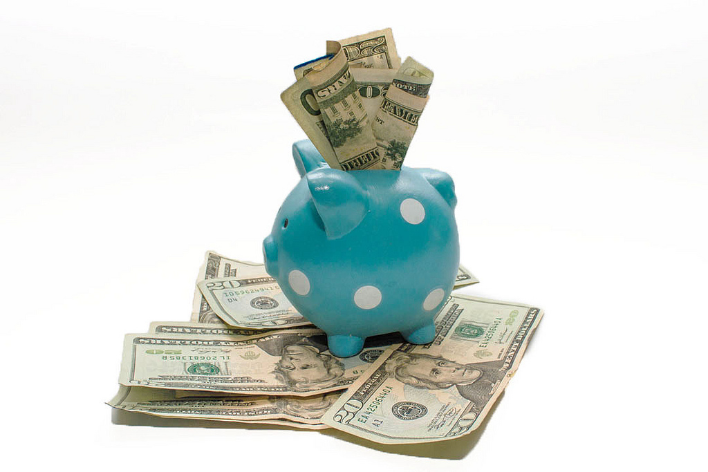 Dollars in a piggy bank. Photo: OTA Photos/Flickr
